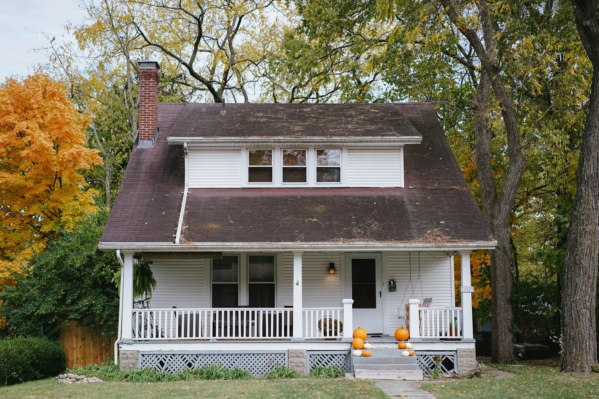 Craftsman bungalow with a front porch in autumn